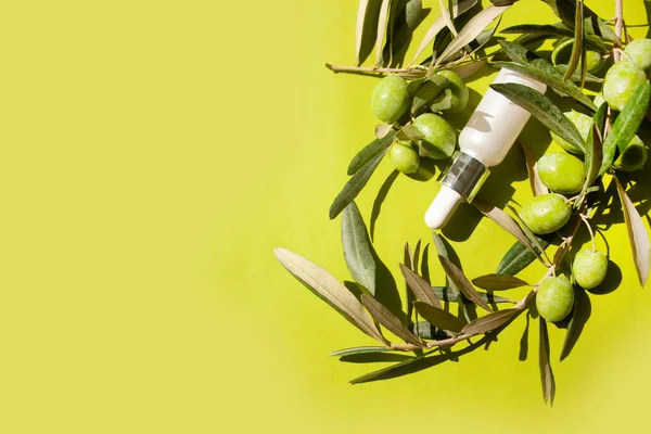 Cosmetic olive oil and serum on a green background. Flat lay style. Natural cosmetic