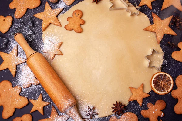 stock image Cooking gingerbread on a black background. Baking, tins, stars for the new year. Flat lay style