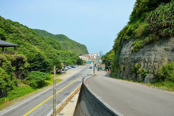 stock image Traffic at Bitou Road during the day, the beginning point of famous Bitoujiao Hiking Trail surrounded by high mountain of Bitou Cape in Ruifang district of New Taipei City, Taiwan