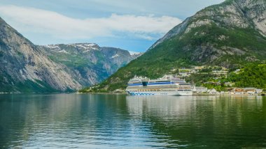 Ferry Cruise Liners Transferring Tourists Docking at Pier On Geiranger Fjord, Norway clipart