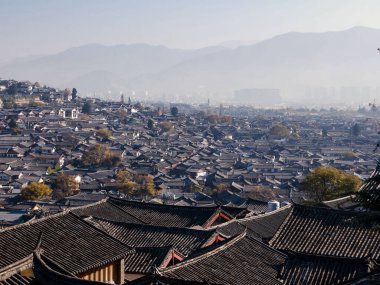 The sea of traditional old rooftop scenic view from the top over the Old Town of Lijiang, the most popular tourist destination of Lijiang, Yunnan of China, UNESCO World Heritage Site clipart