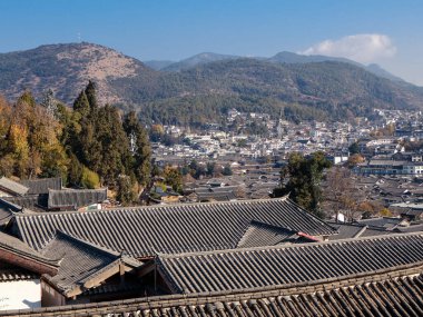 The sea of traditional old rooftop scenic view from the top over the Old Town of Lijiang, the most popular tourist destination of Lijiang, Yunnan of China, UNESCO World Heritage Site clipart