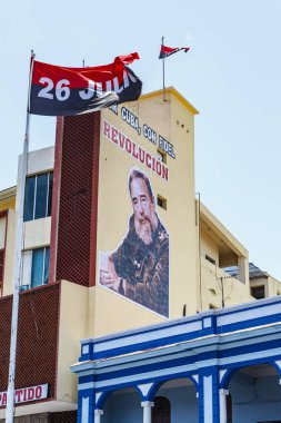 Communist Revolution banners and street advertising with Fidel Castroon colonial buildings in the center of Santiago de Cuba, Cuba, Caribbean