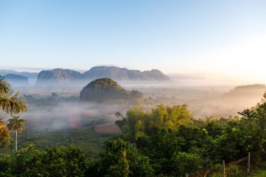 Morning fog over the Valley of Vinales with its big mogotes mountains and tobacco plantations, an Unesco World Heritage Site in Cuba, Caribbean