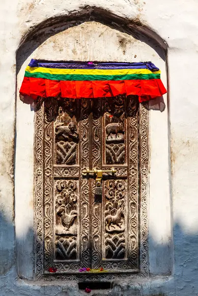 stock image Old wooden door with animal carvings in the facade of the Bouddha, also known as Boudhanath in Kathmandu, Nepal, Asia