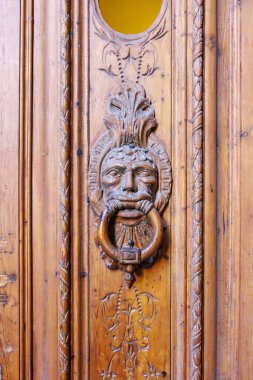 Wooden door with carved male faces, Gothic Quarter,  Barcelona, Catalonia, Spain, Europe clipart