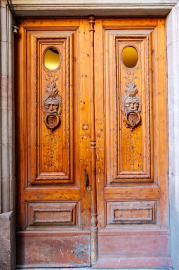 Wooden door with carved male faces, Gothic Quarter,  Barcelona, Catalonia, Spain, Europe clipart