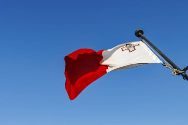 Flag of Malta against a blue sky, Valletta, Malta, Europe clipart