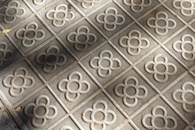 Sidewalk with panot (tiles with flower inside) in Barcelona, Catalonia, Spain, Europe