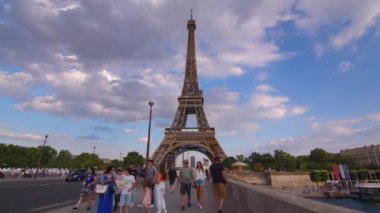 Timelapse, movement of clouds. People walk in Paris with the Eiffel Tower in the background. The most popular tourist attraction in the world. Paris, France. High quality 4k footage