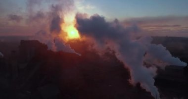 Aerial view. Emission to atmosphere from industrial pipes. Smokestack pipes shooted with drone. High quality 4k footage
