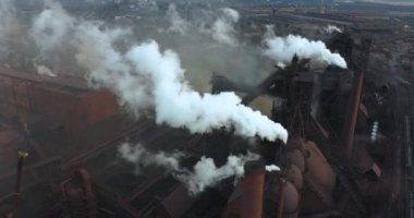 Environmental pollution with industrial smoke from a large pipe shot from a high altitude. Climate change on the planet and global warming. Factory pollutes environment. High quality 4k footage