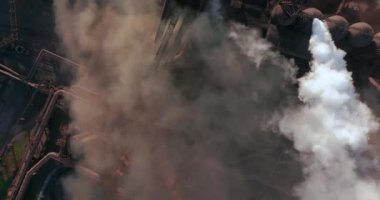 Aerial view. Emission to atmosphere from industrial pipes. Smokestack pipes shooted with drone. High quality 4k footage