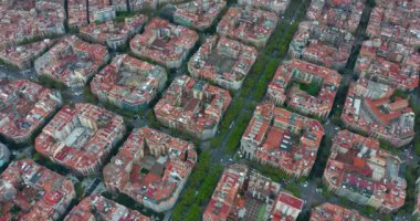 Aerial view of the streets of Barcelona. A drone flies over the rooftops of a Spanish city. Aerial view of typical buildings of Barcelona cityscape. High quality 4k footage