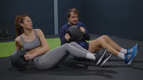 Young Determined Athletic Couple Performing Exercise Fitness Balls Gym Club — Stockvideo