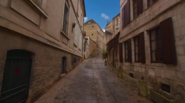 View of a beautiful street with old traditional French houses in the center of Auxerre with clouds in the background. Legacy of French history. Historic hotels, colorful houses in France. Time Lapse.
