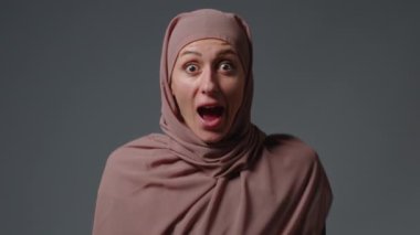 Wow face. Surprised woman in hijab. High quality 4k footage