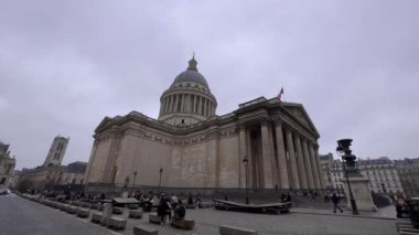 Paris, France, 22 February 2023: National pantheon building front view with street and people. Traffic on the street, cloudy weather. Paris, France. High quality 4k footage