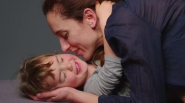 Authentic close up shot of young neo mother is playing with her baby in a nursery in a morning. Shot in 6K. Concept of children, baby, parenthood, childhood, life, maternity, motherhood.