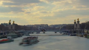 Beautiful Parisian bridge over the river Seine with golden sculptures and street lamps. Alexandre Bridge in Paris. Grand Palais on background. Paris, France. High quality 4k footage