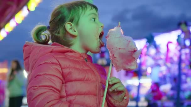 Маленька Дівчинка Їсть Рожеві Бавовняні Цукерки Святкових Дитячих Заходах Тлі — стокове відео