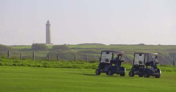 ゴルフ車はフランスの大西洋岸の緑のゴルフコースに立つ — ストック動画