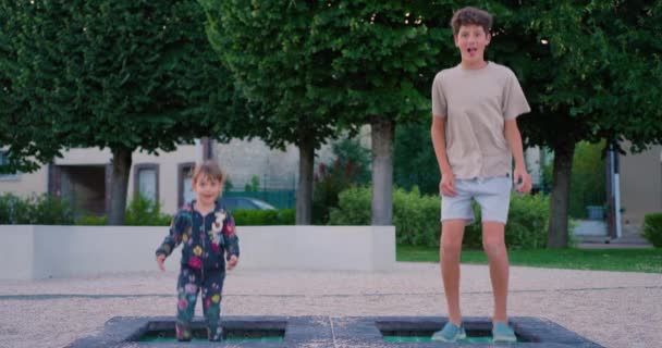 행복한 아이들은 공원에서 트램폴린에 자매와 형제는 트램폴린에 쾌활한 소년과 소녀의 — 비디오