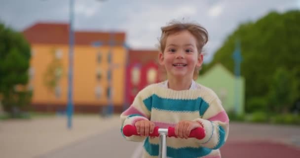 Schöne Kleine Mädchen Auf Einem Motorroller Auf Der Straße — Stockvideo