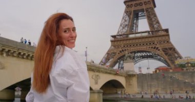 Eyfel Kulesi 'nin yakınındaki Seine Nehri' nde bir turist gemisinde tekne gezisi. Ünlü Eyfel Kulesi 'nin simgesine bakan turist kadın..