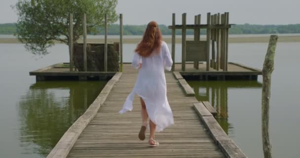 Girl Runs White Clothes Pier Lake Living Green Tree Grows — Stock Video