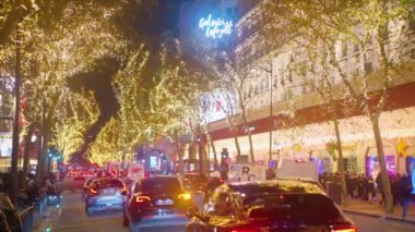 Paris caddesi Noel süslemeleri ve ışıklarla süslenmiş. Alışveriş yapan bir sürü insan. Noel havası.