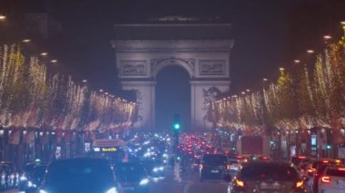 Fransa 'nın başkenti Paris' te kutlama renklerinde dekorasyonlar. Paris 'te Noel. Güzel bir akşam, Paris Noel için dekore edilmiş, şehir merkezinde trafik var..