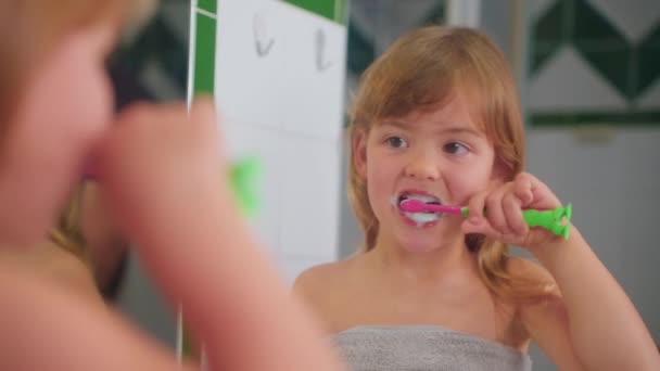 可爱的小女孩看着镜子刷牙 儿童的日常保健服务 后续行动 — 图库视频影像
