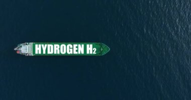 Mavi okyanusta büyük yeşil bir gemi önemli bir yük taşıyor. Tanker hidrojen enerjisi kullanır. Kargo taşımacılığı için yenilenebilir enerji. Sevkiyat dünyanın her yerinde ticaretin lokomotifi..