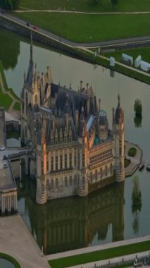 Chantilly Castle, France. Incredible view of the castle and its surrounding area at sunset from a drone.