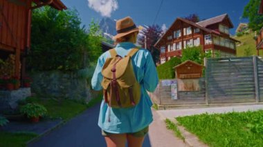 Mavi gömlekli ve şık şapkalı çekici bir kız tatilini Alp çayırlarında yalnız geçirir. Sırt çantalı bir turist inanılmaz manzarayla İsviçre 'yi geziyor..