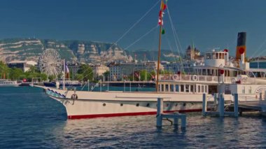 Cenevre, İsviçre, 30 Temmuz 2024: İsviçre 'de İsviçre Bayrağı ile birlikte bir vapur gemisi. İsviçre yaz turizmi merkezi. Turkuaz mavi su.