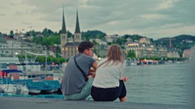 Lucerne Gölü kıyısında oturan çift yazın arka planda Lucerne, İsviçre.