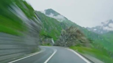 İsviçre 'de Alp Vadisi' nde dağ yolunda araba sürerken. İsviçre Alplerinde araba sürüyorum. Zaman ayarlı..