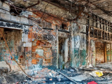 A view through an empty door into an abandoned automotive factory in Detroit.