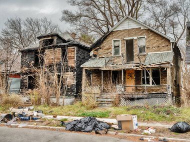 Two houses are abandoned and partially burned in Highland Park near Detroit.