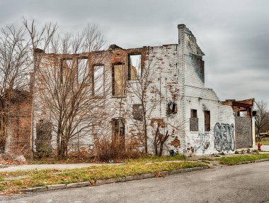 Urban blight in Detroit is visible in an old brick commercial building that has been abandoned and partially destroyed.