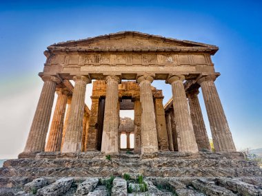 The entrance to the Temple of Concordia is illuminated at dusk in the Valley Of The Temples near Agrigento, Sicily. clipart