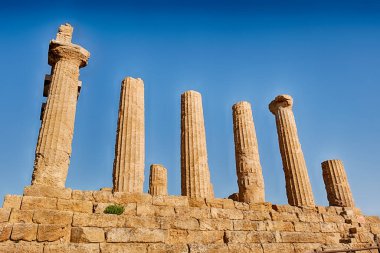 Some of the columns remain standing at the Temple of Juno at the Valley Of The Temples near Agrigento on Sicily. clipart