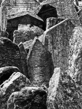 The gravestones in the Josefov Cemetery in Prague are tightly jammed in and somewhat tipped over. In black and white. clipart