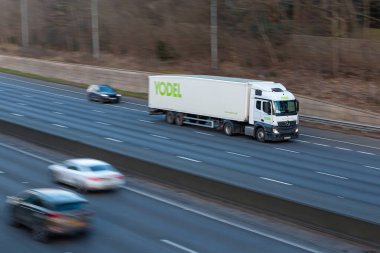 Chorleywood, UK - February 25, 2023: Lorry belonging to Yodel delivery service in motion on the british motorway M25