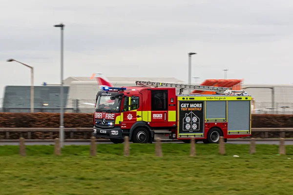 stock image London, UK - March 4, 2023: London's fire engine on blue lights responding to an emergency.