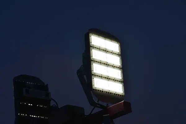 Close up of mobile led flood lights with generator during night time.