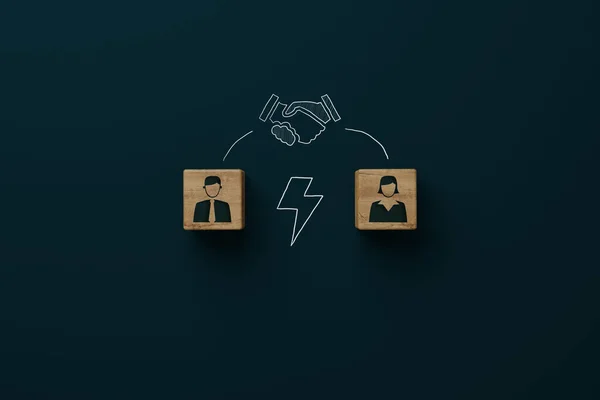 Wooden blocks with an icon of a man, woman, lightning bolt and shaking hands with consent. Divorce, mediation concept. Troubleshooting by a mediator.