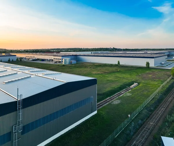 stock image Pictures from the drone on the warehouse building. Concept for storing goods, shipping for stores, ecommerce, online stores. Aerial view on warehouses.